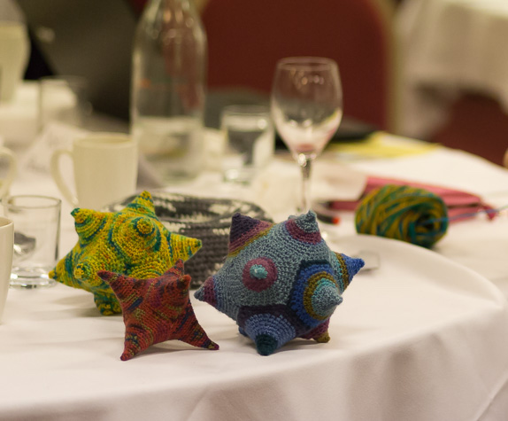 Knitted icosahedra on a table; Photo by Steve Kirkby (steve.kirk.by)