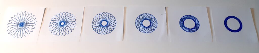 A range of spirograph drawings using different holes on the same cog