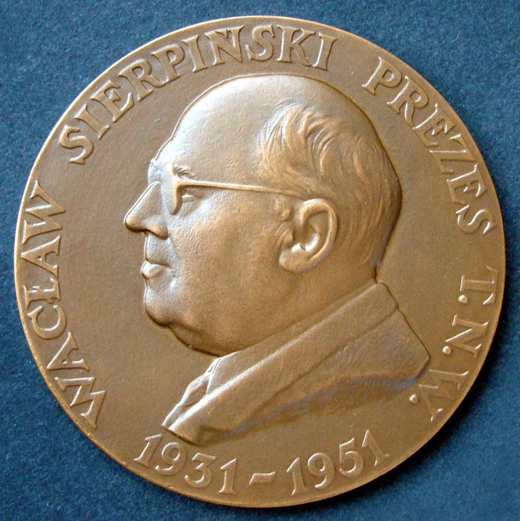 A bronze coin showing a profile of Waclaw Sierpinski, a bald-headed man with glasses. Text around the coin edge reads 'Waclaw Sierpinski Prezes T.N.W; 1931-1951'