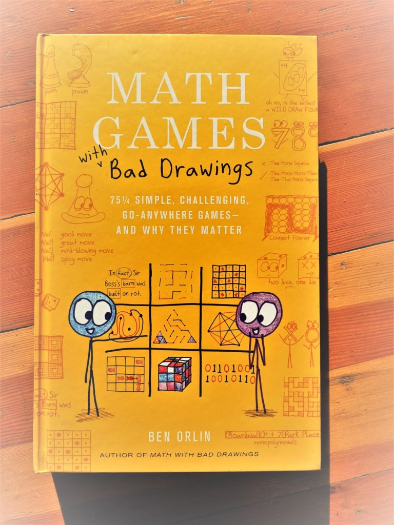 Photograph of the book cover. It's big (did we mention that) and yellow, and covered in drawings of jokes about games.