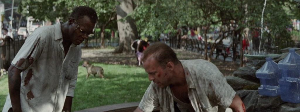 Still from Die Hard With A Vengeance, showing Bruce Willis, Samuel L Jackson and some water jugs