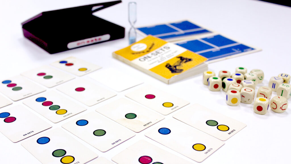 Cards with coloured dots and dice with coloured dots and mathematical symbols