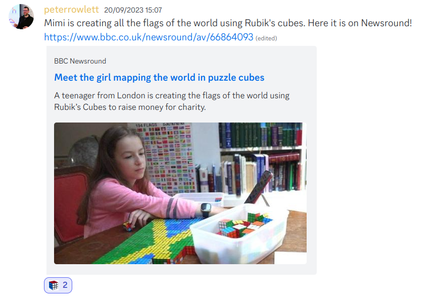 Peter Rowlett posted “Mimi is creating all the flags of the world using Rubik's cubes. Here it is on Newsround!” with the link https://www.bbc.co.uk/newsround/av/66864093 which displays as a picture of a teenager arranging Rubik’s cubes on a table top into a flag pattern with text “Meet the girl mapping the world in puzzle cubes. A teenager from London is creating the flags of the world using Rubik’s Cubes to raise money for charity.” After the post is the note “(edited)”. Under the post is a small Rubik’s cube and the number 2.