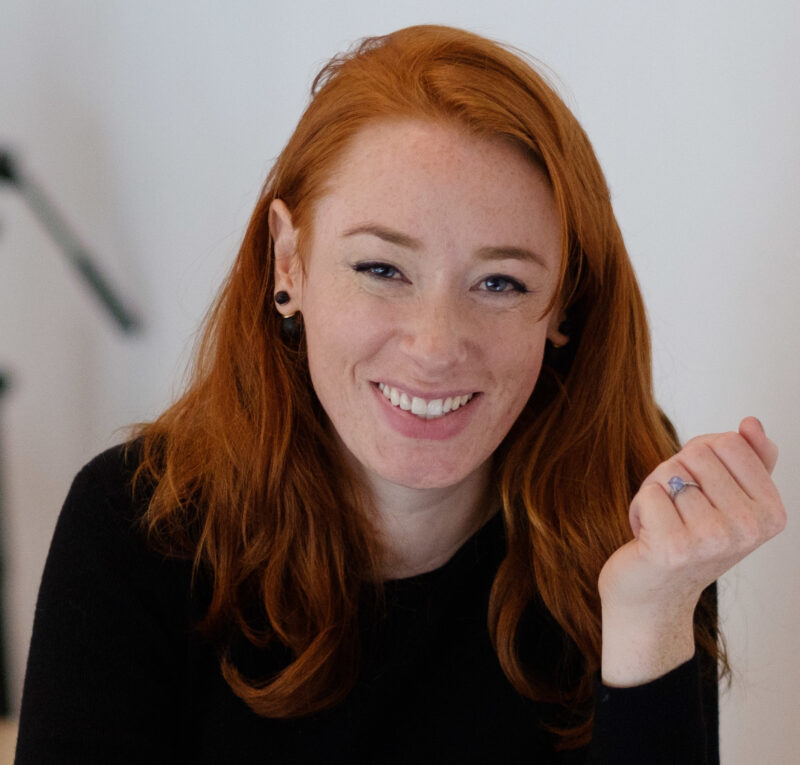 Photo of Hannah Fry, a young white woman with long red hair, smiling