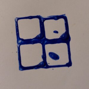 Four squares printed together, to make a bigger square. They don't line up exactly and there are splodges of paint in the middle.