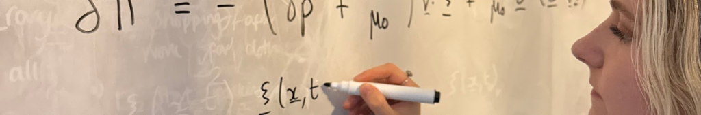 Photo of Ellie writing maths on a whiteboard
